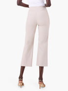 Cream high-waisted wide-leg crop pants, shown from the back, with legs ending above the ankles.