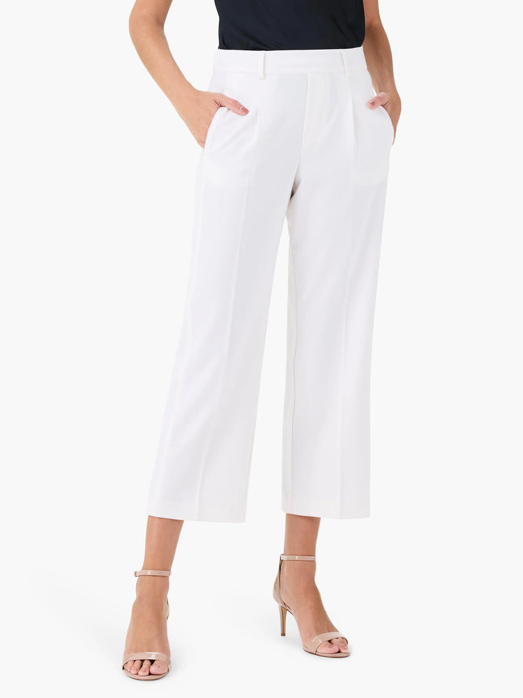 Off-white wide-leg cropped trousers; front pleats; pockets.  Model wears nude heels.