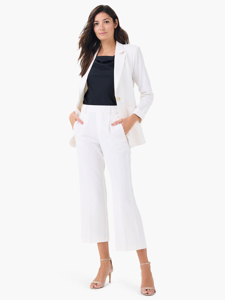Off-white wide-leg cropped trousers; model also wears a white blazer and black top.