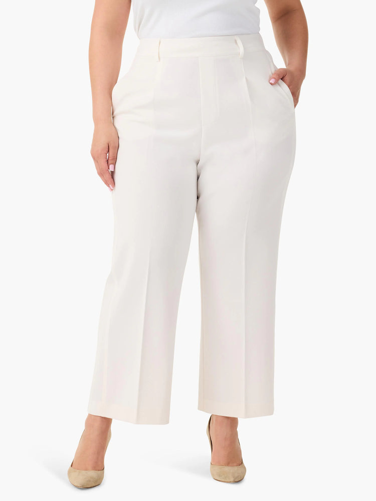 Off-white wide-leg cropped trousers;  high-waisted with pleats. Model wears nude heels.