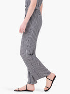 Black and white gingham wide-leg pants.  Model shown wearing black sandals.