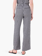 Black and white gingham wide-leg pants; rear view.