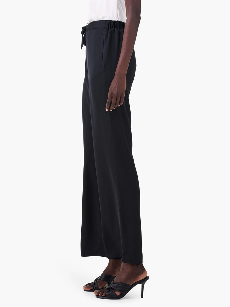 Black wide-leg pants with drawstring waist.  Side profile shows fabric drape.