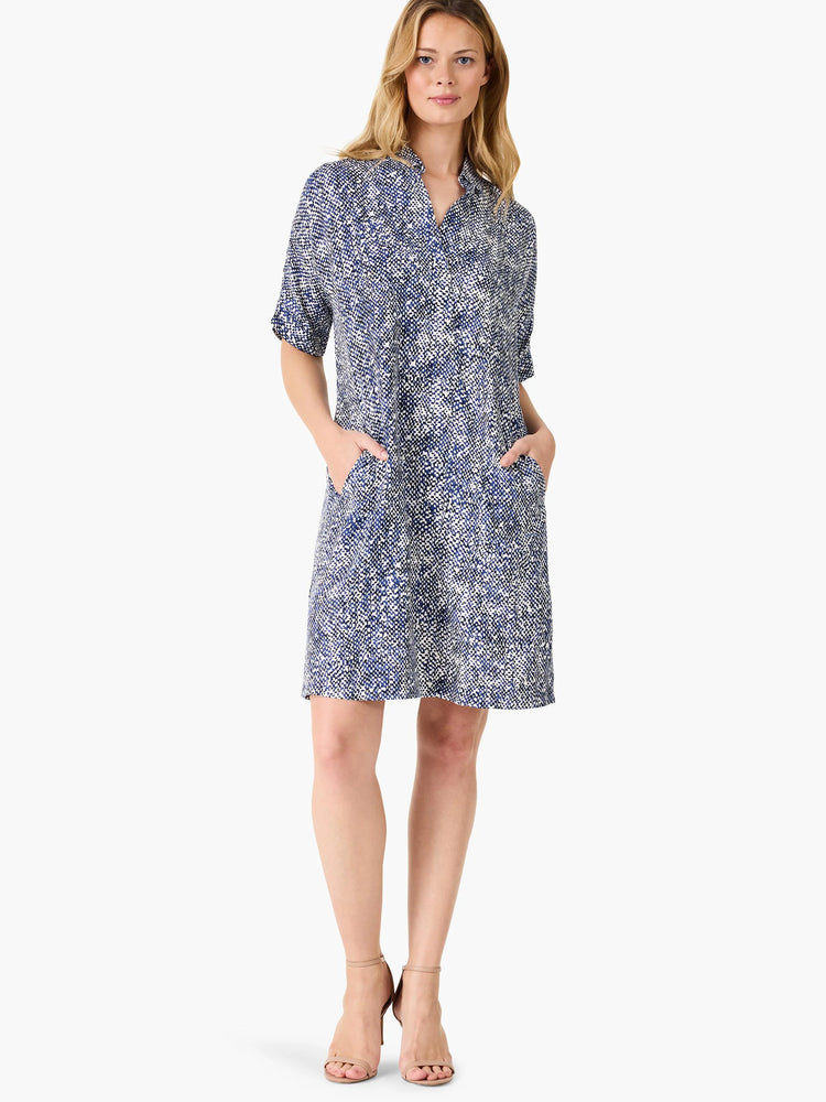Short, collared dress in navy blue and white speckled pattern.  Has short sleeves and two pockets.