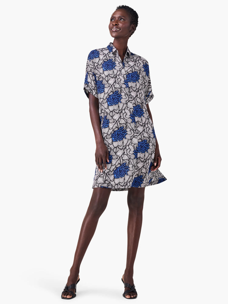Short, collared shirt dress with short sleeves.  Off-white background, dark blue floral pattern.