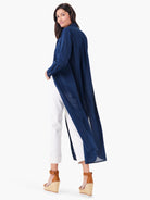 Navy blue, long-sleeved tunic; shirt-style collar;  side slits; knee-length.