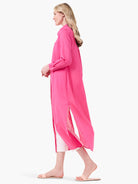 Pink long-sleeved tunic shirt with a center slit, shown on a model.