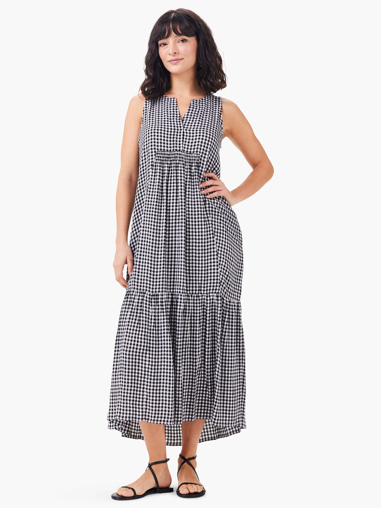 Black and white gingham sleeveless maxi dress with tiered skirt and V-neck.