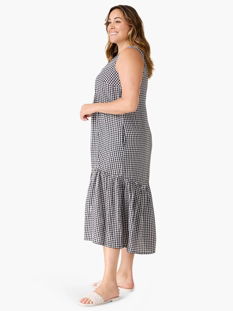 Black and white gingham sleeveless midi dress with a tiered ruffle hem.