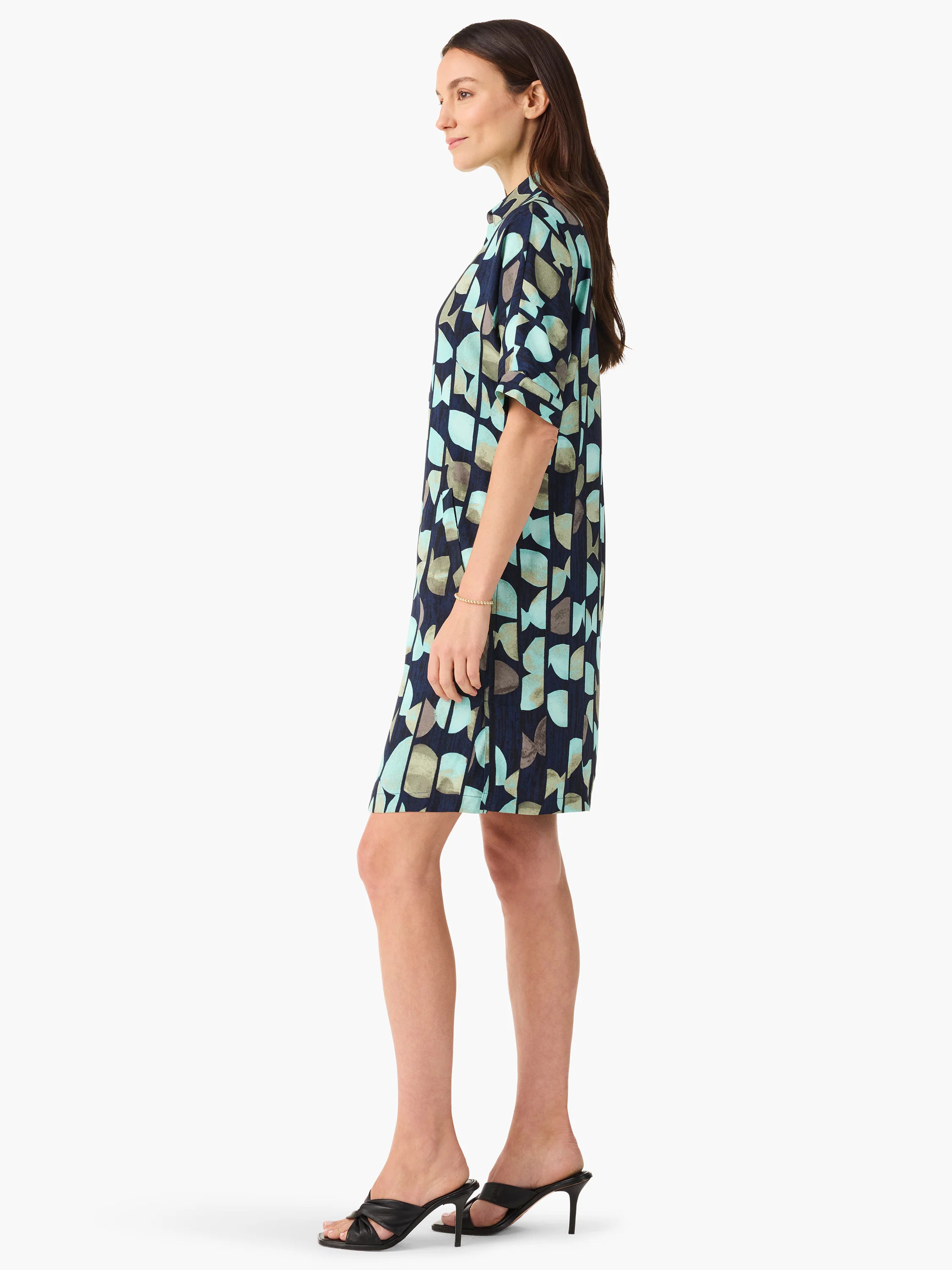 Side view of short navy dress with teal and gray abstract print.  Short sleeves.