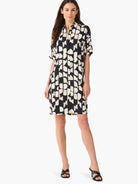 Black short-sleeved shirt dress with an abstract beige and black pattern.