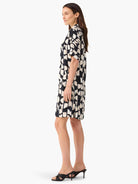 Black and off-white abstract print short-sleeved shirt dress.  Side view.