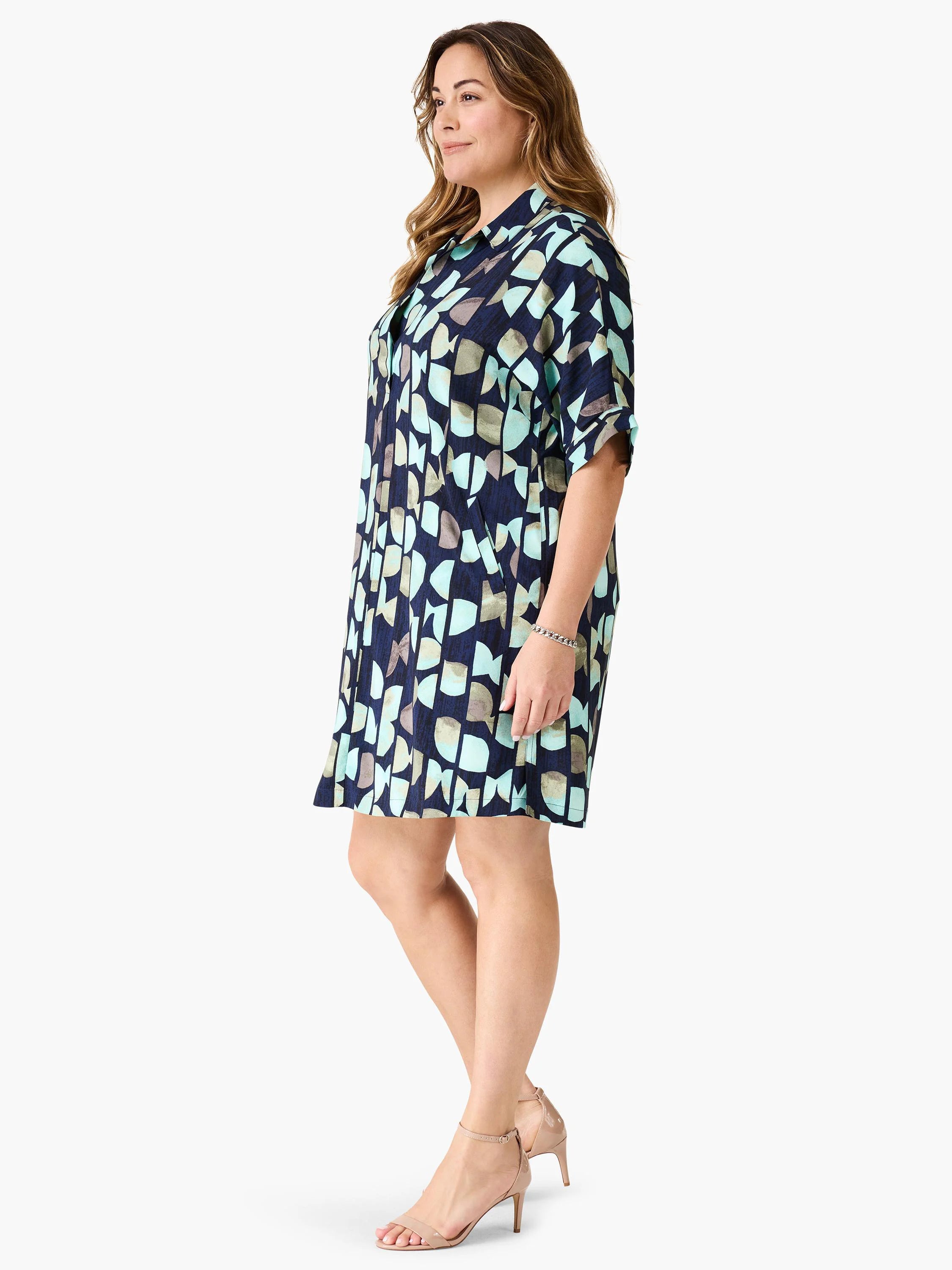 Navy blue shirt dress with teal, gray, and beige abstract print. Short sleeves, collared.