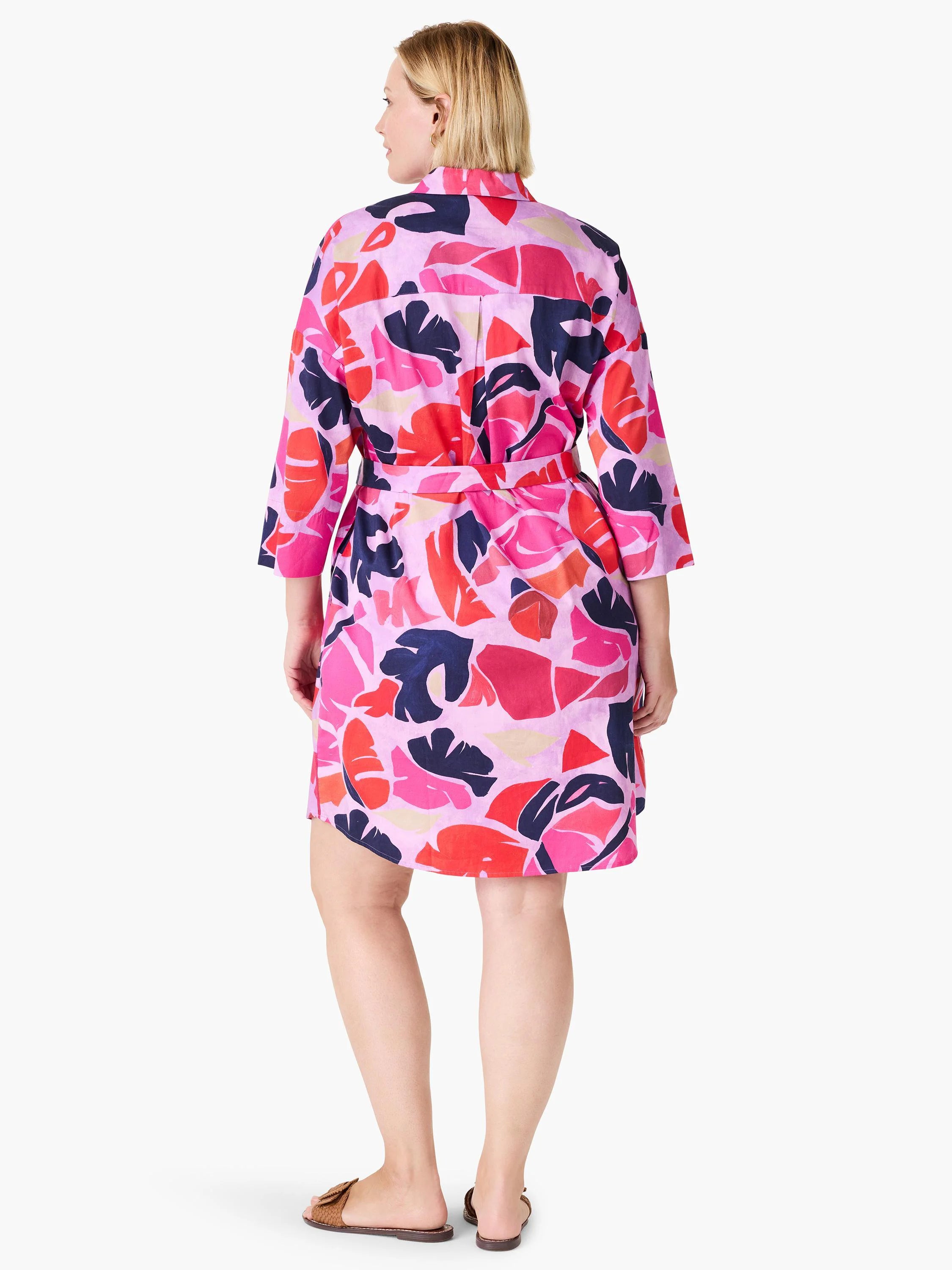 Pink shirt dress with red, orange, and navy leaf print.  Three-quarter sleeves, belted waist.