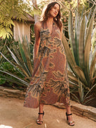 Maxi halter dress, rust, black, and beige palm print.  V-neck, sleeveless, A-line silhouette.