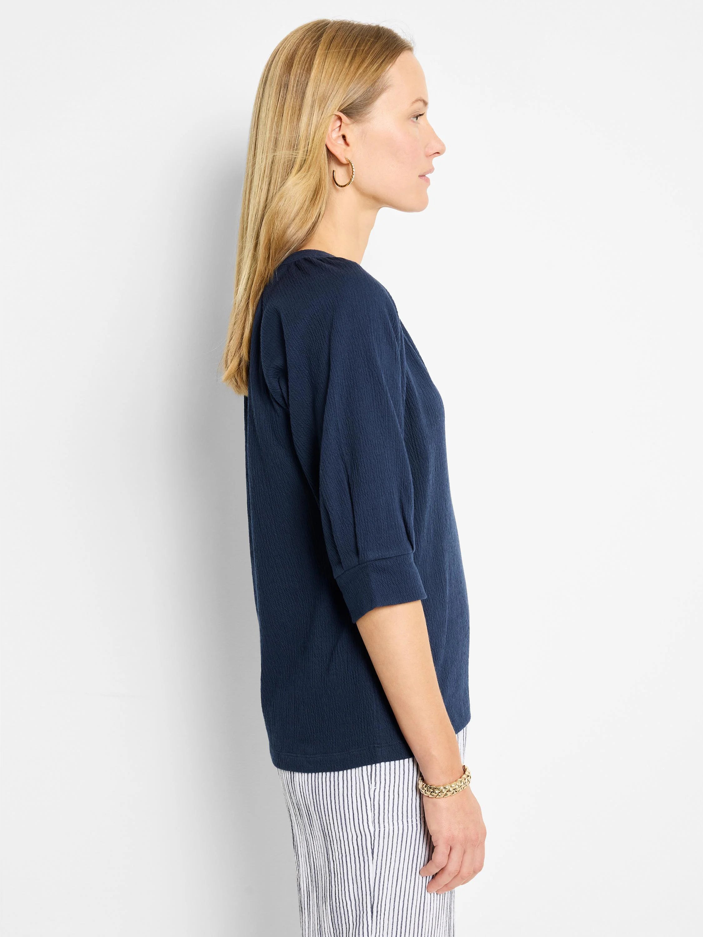 Dark navy blue, textured knit top.  Three-quarter sleeves, round neckline.