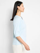 Light blue, textured knit top.  Three-quarter sleeves, round neckline with keyhole detail.