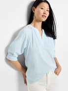 Light blue, crinkled textured knit top.  Three-quarter sleeves, V-neck.