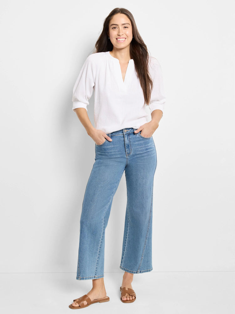 White, textured knit top with V-neck and three-quarter sleeves.
