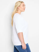 White, textured knit top with 3/4 sleeves and a slightly rounded neckline.