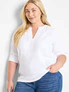 White, textured knit top.  V-neck, 3/4 sleeves.