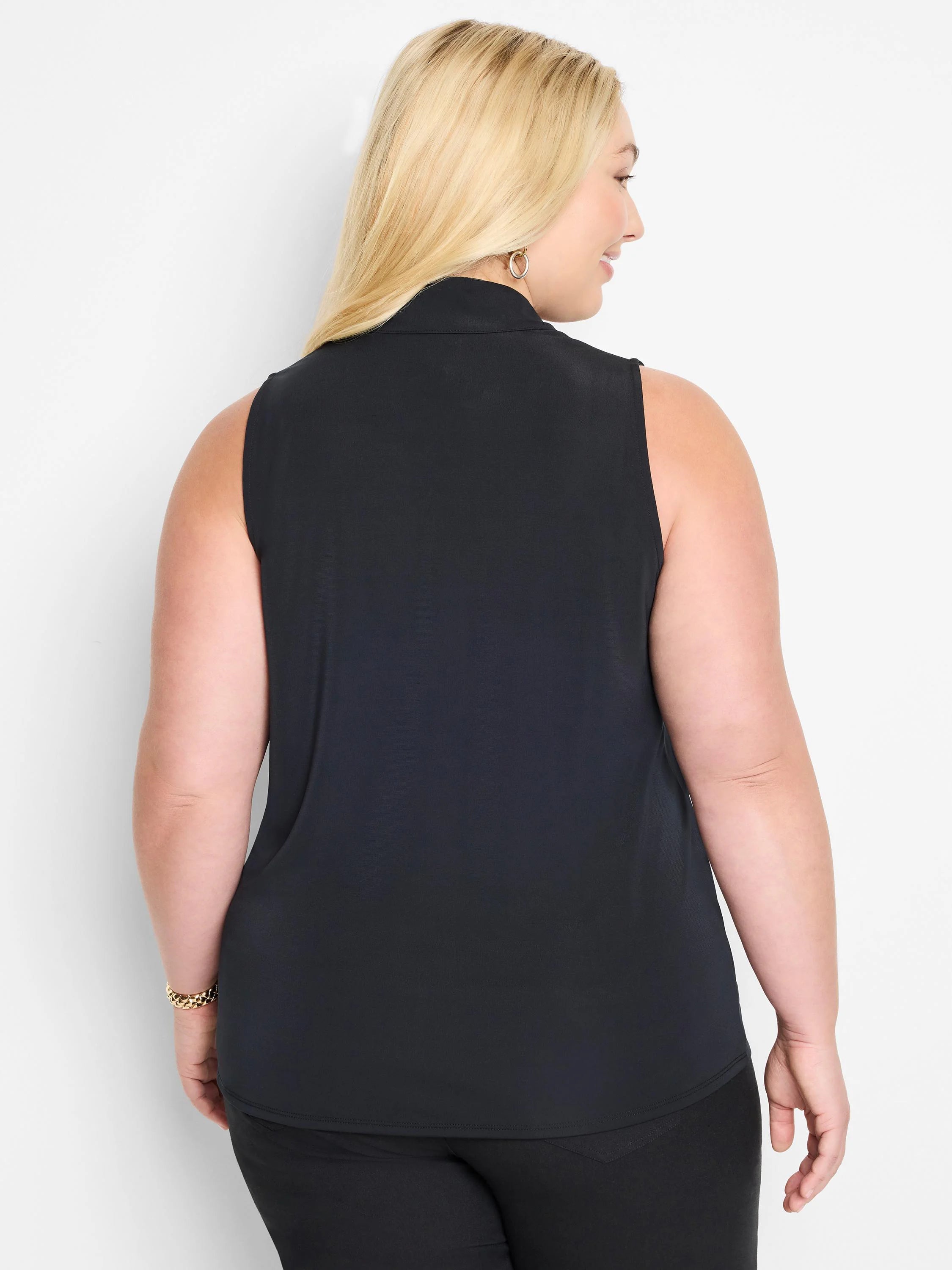 Black sleeveless knit top with mock neck.  Slight ruffling at neckline.