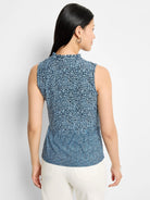 Sleeveless knit tank; blue and white geometric pattern. Mock neck, ruffled neckline.  Slightly flared hem.