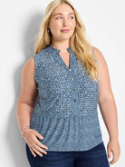 Sleeveless blue and white geometric print knit tank top with button placket.