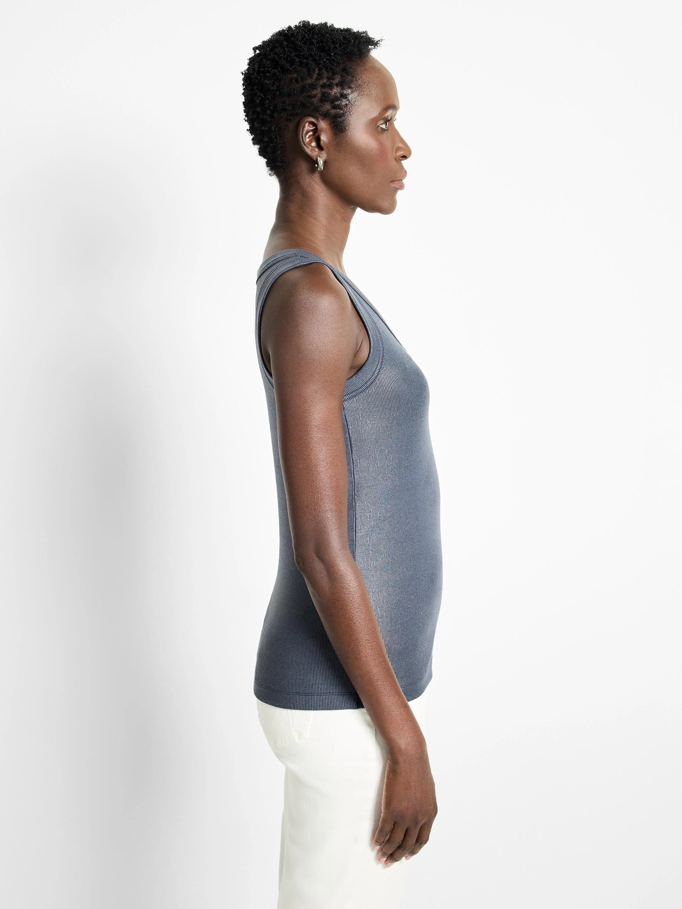 Dark slate ribbed tank top with a subtle sheen, V-neck, fitted. Model shown in profile.