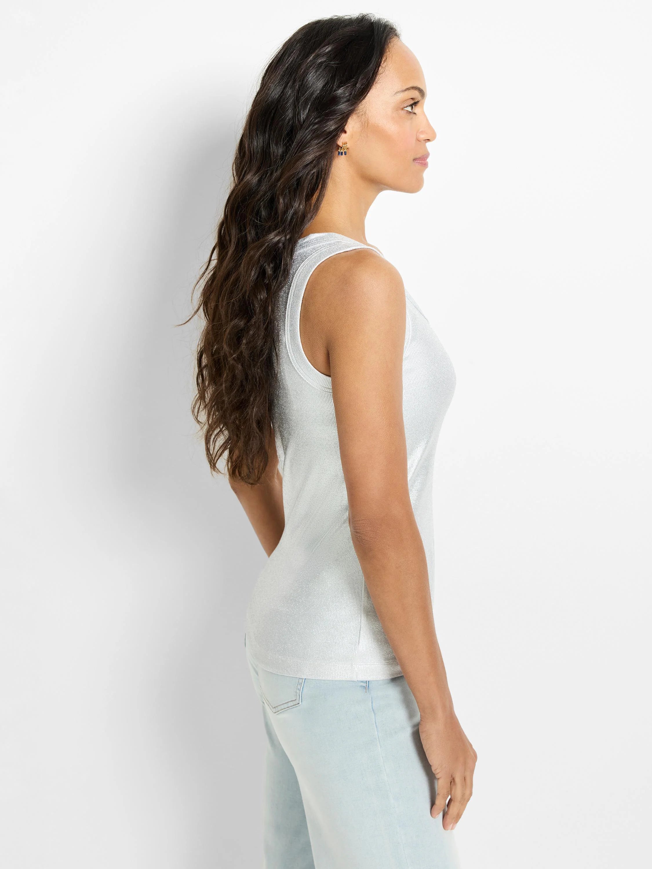 Sleeveless, shimmery silver ribbed tank top, modeled from the side.