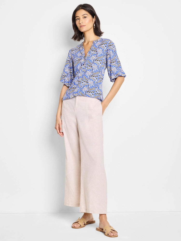 Blue top with beige and black abstract print, short sleeves, V-neck.