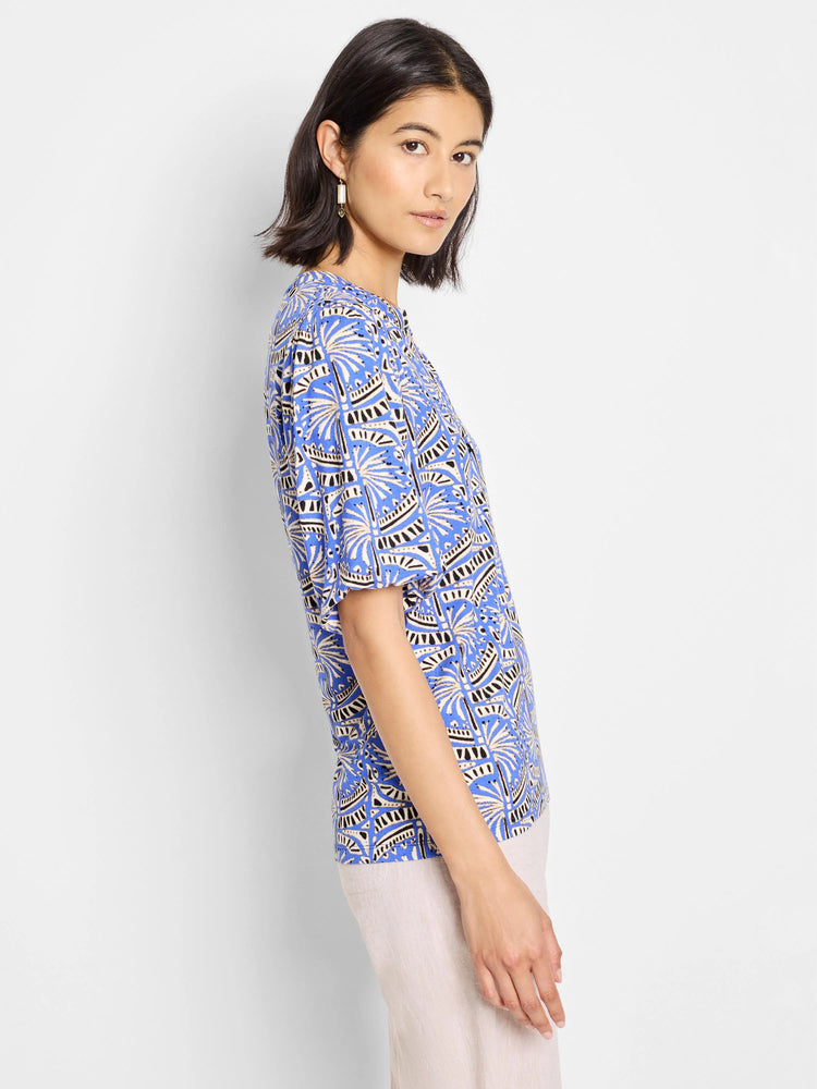 Blue top with short sleeves, featuring a beige and black geometric print.