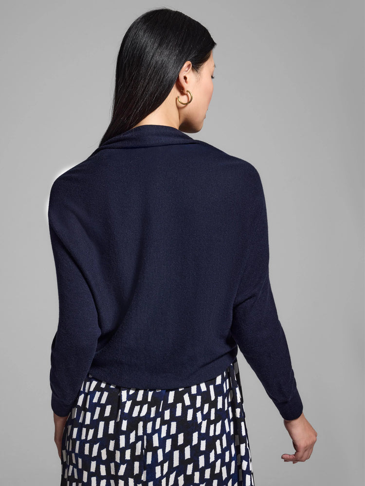 Navy blue, long-sleeved shrug cardigan; open front, draped neckline.