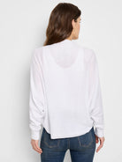 White cotton cashmere shrug cardigan, long sleeves,  boxy fit.  Shown from the back.