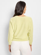 Pale yellow, V-neck, long sleeves, knit cotton sweater; shown from the back.