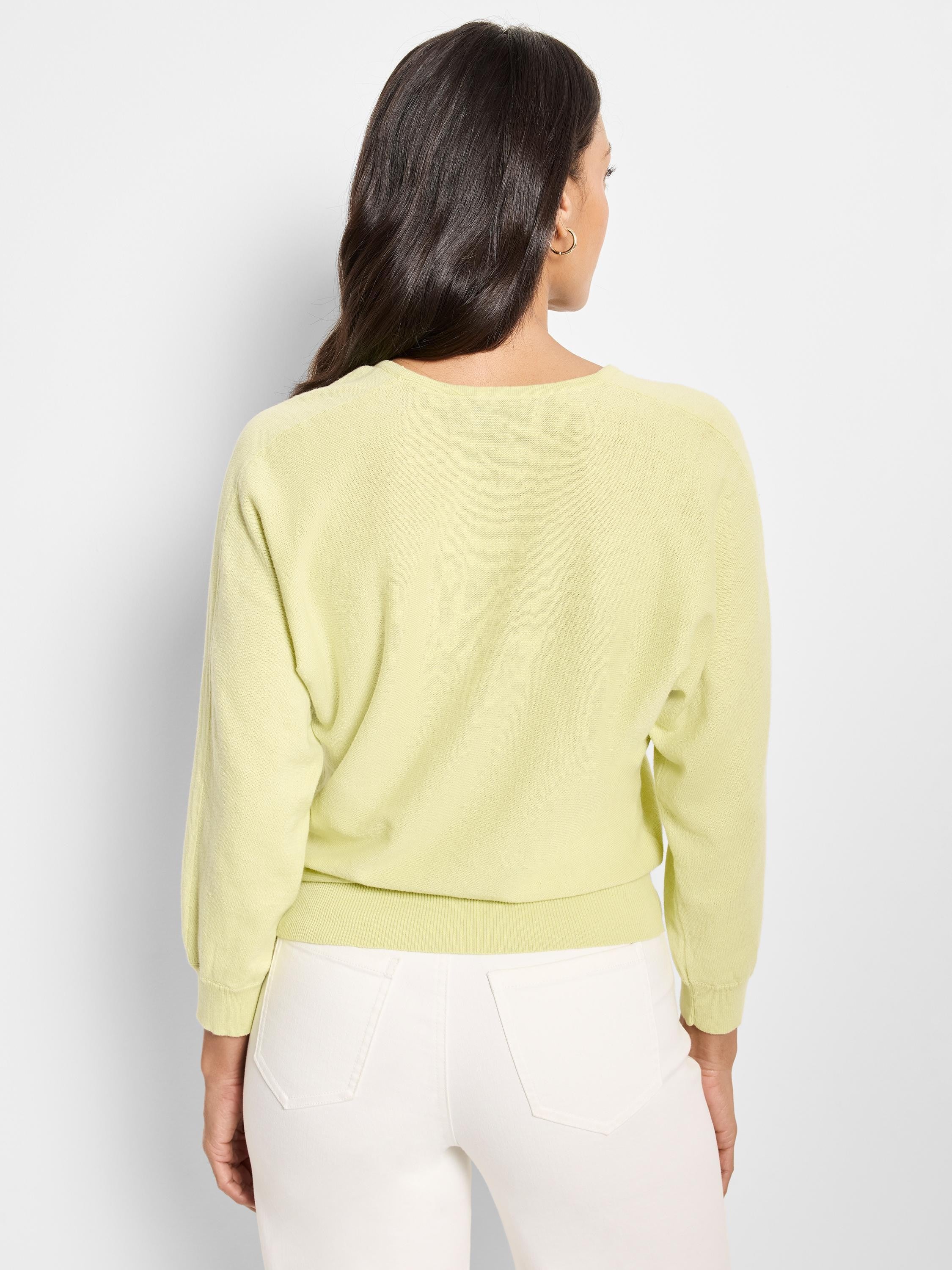 Pale yellow, V-neck, long sleeves, knit cotton sweater; shown from the back.