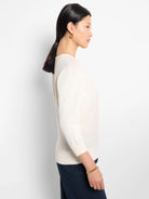 Off-white V-neck sweater, three-quarter sleeves, shown on a model.