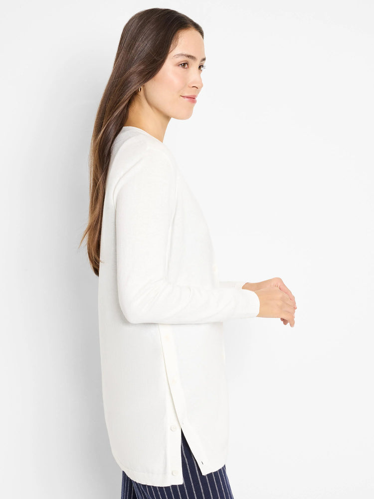 Off-white long-sleeve cardigan, side button closure.