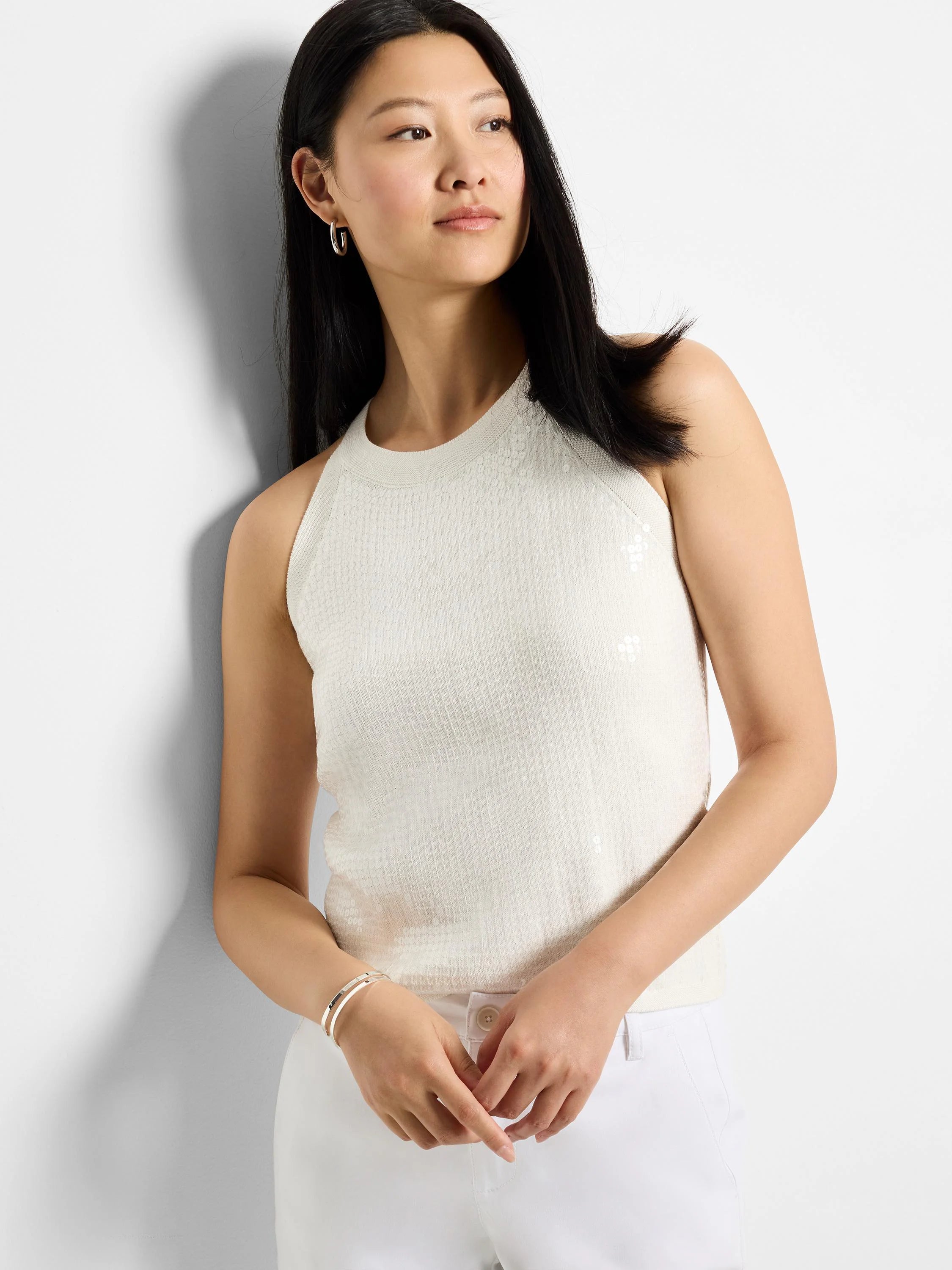 Off-white sequined sleeveless sweater tank; sequins are sparsely scattered.  Racerback style.