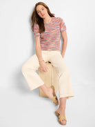 Short-sleeved, multicolor striped knit sweater tee.  Predominantly pink, red, and blue hues.