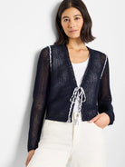 Navy blue mesh tie cardigan with white trim and ties.  Open front.