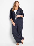 Navy blue mesh cardigan with white trim and ties.  Three-quarter sleeves.