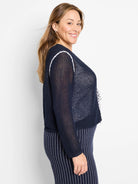Navy blue mesh cardigan with white trim.  Open front, long sleeves.