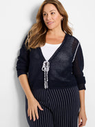 Navy blue mesh tie cardigan.  White trim detail and ties.
