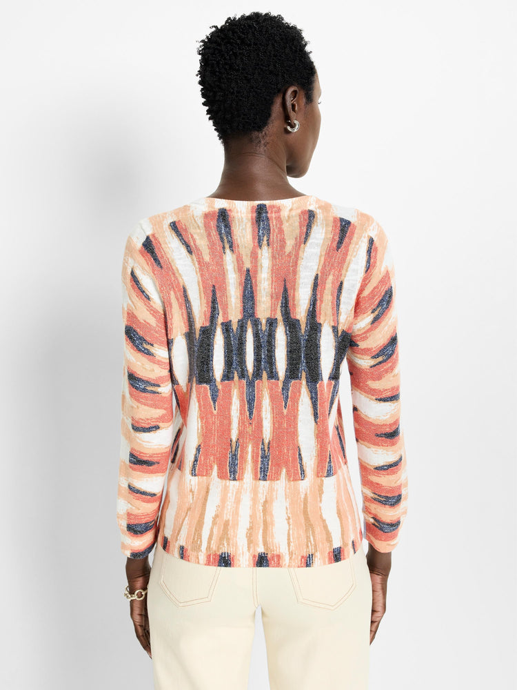 Cream, peach, and dark blue abstract pattern long-sleeve cotton sweater.