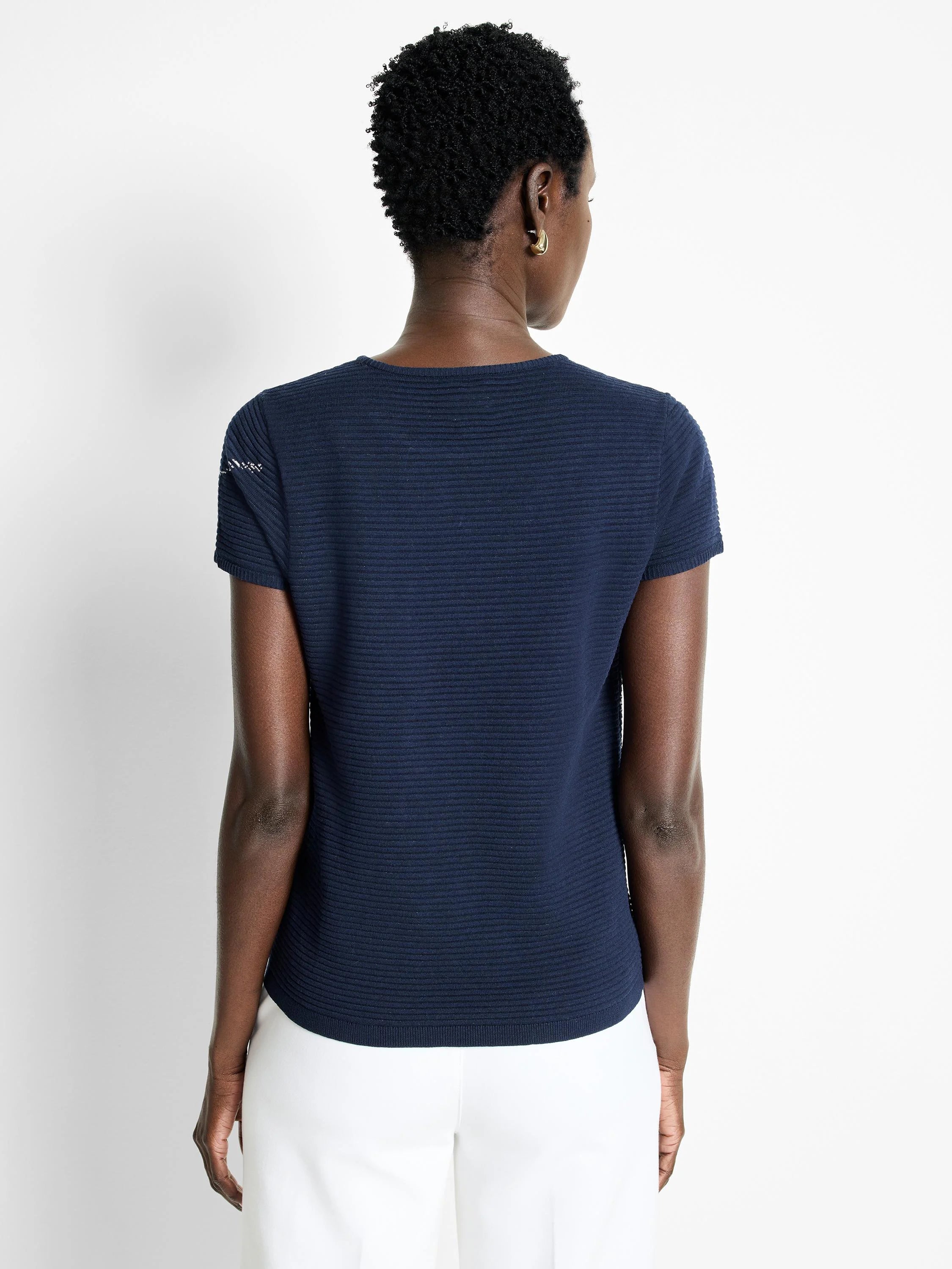 Dark navy blue, ribbed knit short-sleeve tee.  Slight white detail at shoulder.