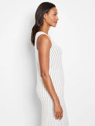 Off-white sleeveless knit tank with thin, dark-grey vertical stripes.