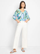 Three-quarter sleeve cotton sweater with an abstract blue, green, and white leaf pattern. V-neck.