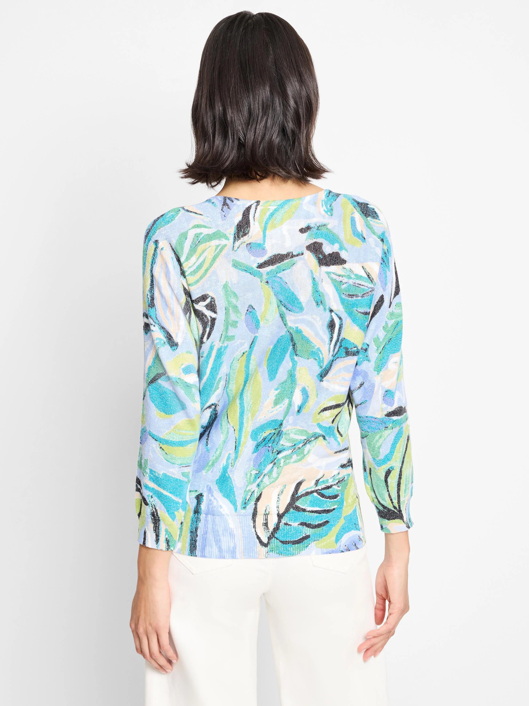 Light blue sweater with teal, green, and white leaf pattern.  Three-quarter sleeves.