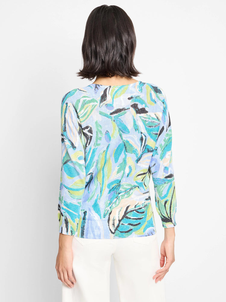 Light blue sweater with teal, green, and white leaf pattern.  Three-quarter sleeves.